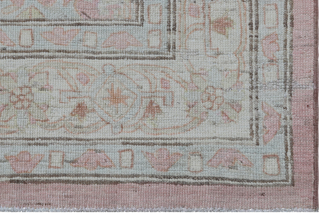 Authentic hand-knotted Afghan runner rug from the Ariana Hazara Collection, featuring geometric Caucasian motifs in pink organic wool.