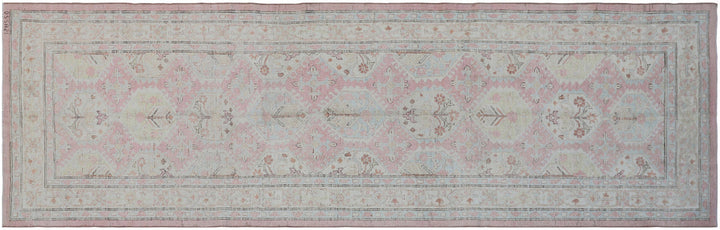 Authentic hand-knotted Afghan runner rug from the Ariana Hazara Collection, featuring geometric Caucasian motifs in pink organic wool.