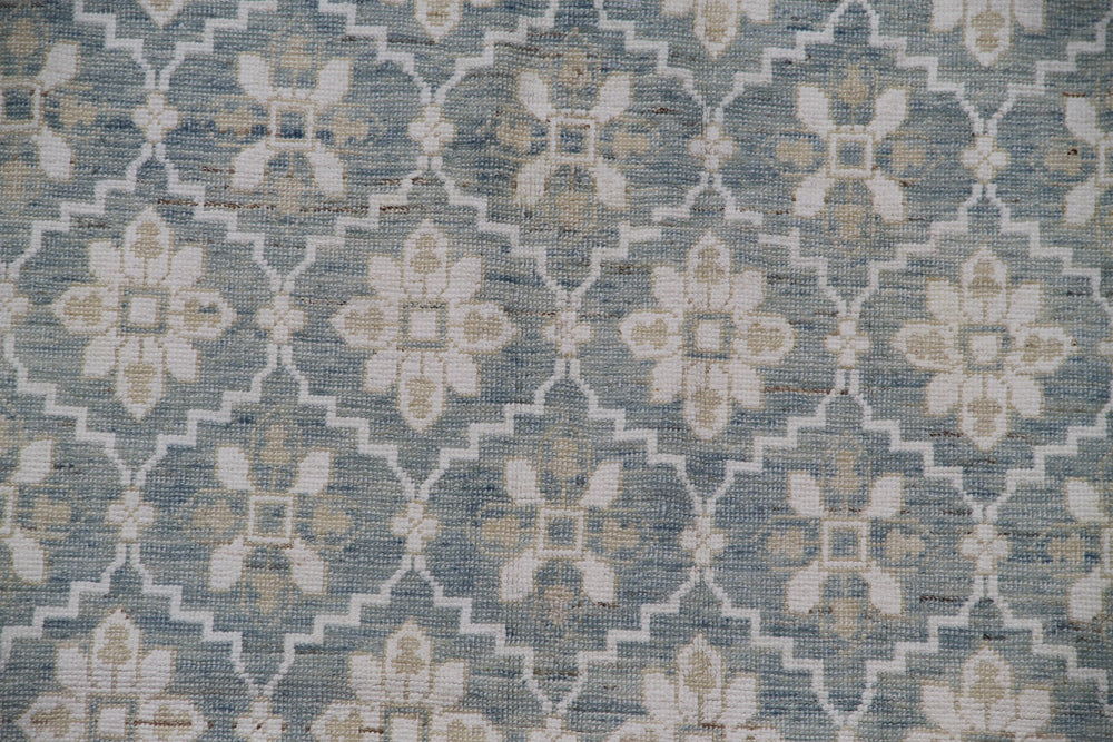 Authentic hand-knotted Afghan area rug from the Ariana Samarkand Collection, featuring a classic geometric design in blue and ivory organic wool.