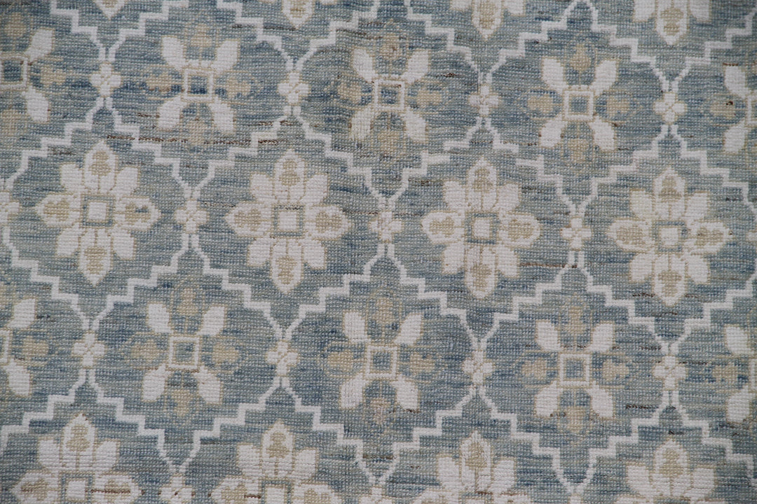 Authentic hand-knotted Afghan area rug from the Ariana Samarkand Collection, featuring a classic geometric design in blue and ivory organic wool.
