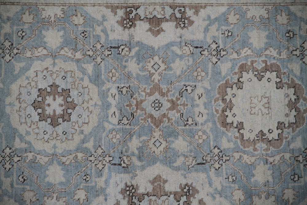 Authentic fine hand-knotted Afghan runner rug from the Ariana Traditional Collection, featuring the Agra 505 Blue design in low-pile blue, ivory, and brown organic wool.