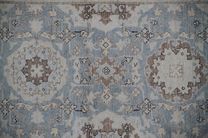 Authentic fine hand-knotted Afghan runner rug from the Ariana Traditional Collection, featuring the Agra 505 Blue design in low-pile blue, ivory, and brown organic wool.