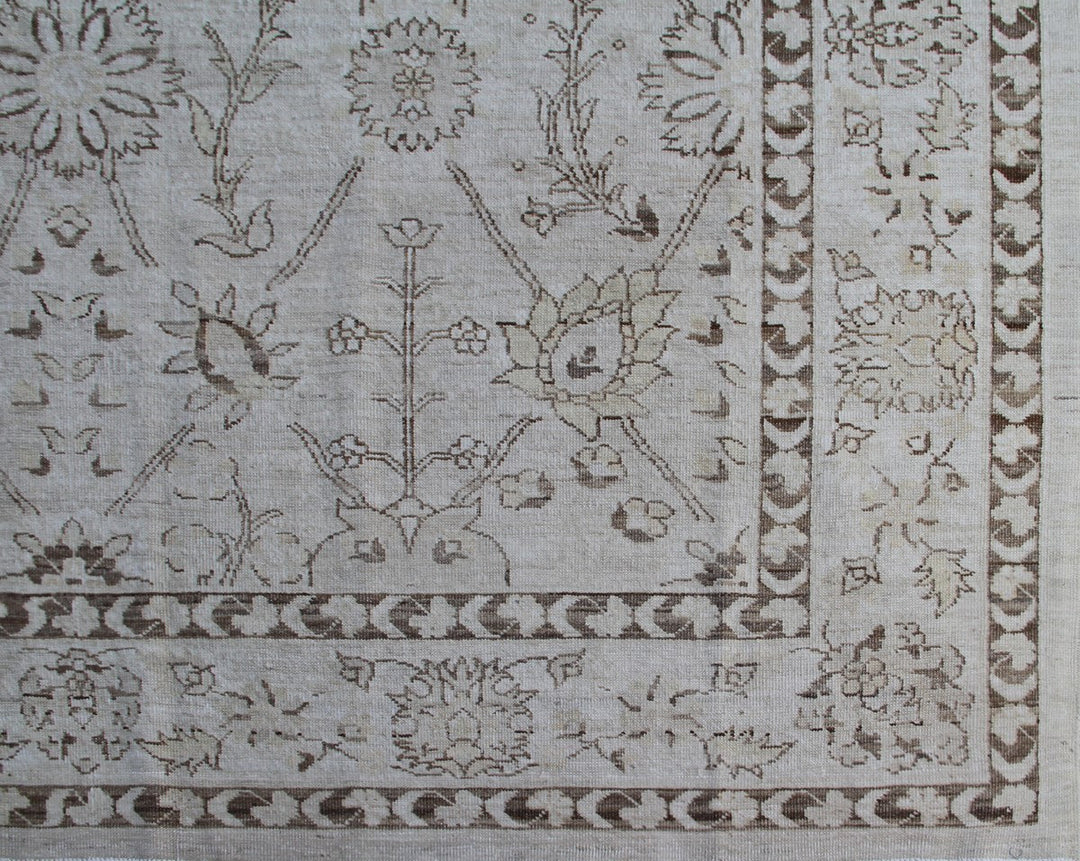 Authentic hand-knotted Afghan area rug from the Ariana Transitional Collection, featuring a classic Tabriz floral design in a low-pile ivory and brown organic wool weave.