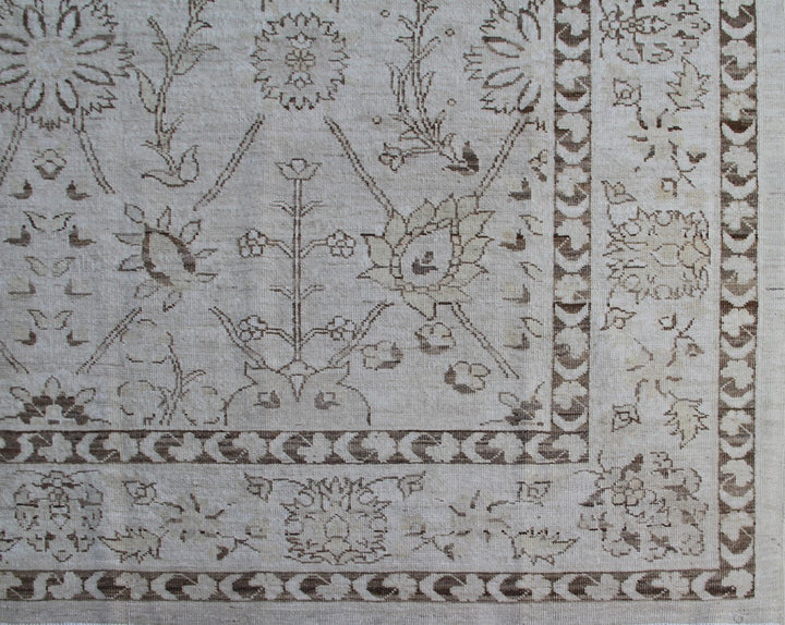 Authentic hand-knotted Afghan area rug from the Ariana Transitional Collection, featuring a classic Tabriz floral design in a low-pile ivory and brown organic wool weave.