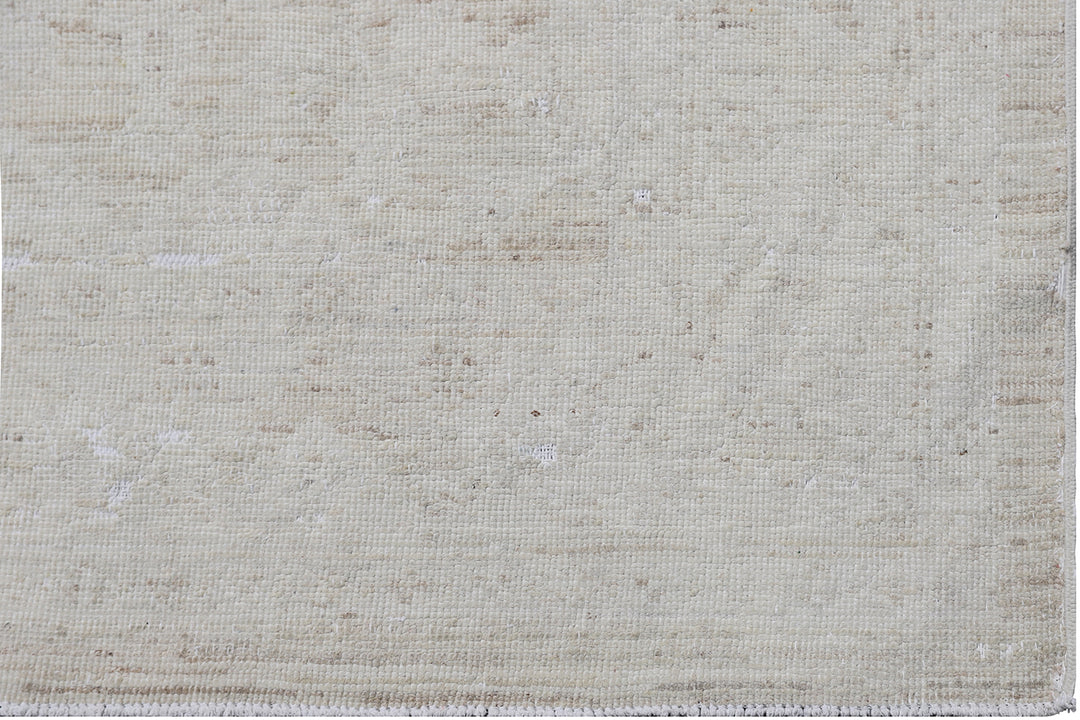 Authentic hand-knotted Afghan runner rug from the Ariana Vintage Collection, featuring a brand-new, beautifully distressed geometric design in pale, muted organic wool tones.