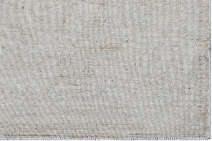 Authentic hand-knotted Afghan runner rug from the Ariana Vintage Collection, featuring a brand-new, beautifully distressed geometric design in pale, muted organic wool tones.