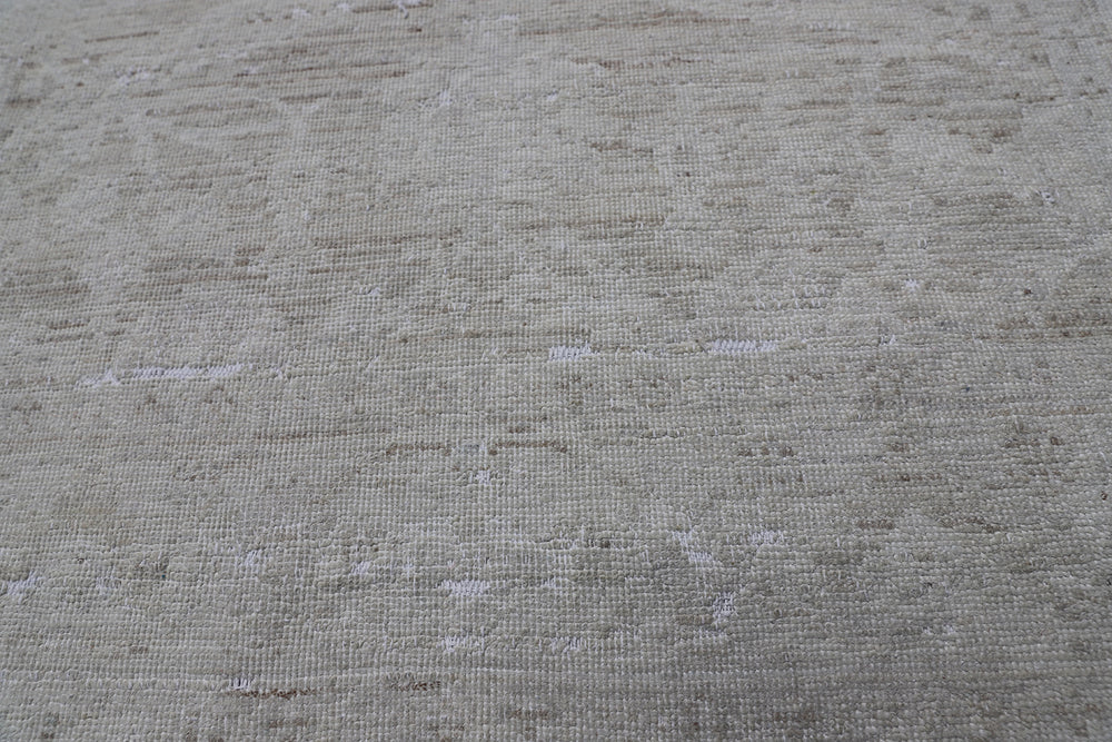 Authentic hand-knotted Afghan runner rug from the Ariana Vintage Collection, featuring a brand-new, beautifully distressed geometric design in pale, muted organic wool tones.