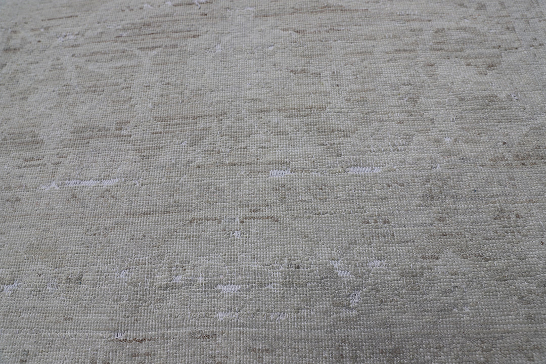 Authentic hand-knotted Afghan runner rug from the Ariana Vintage Collection, featuring a brand-new, beautifully distressed geometric design in pale, muted organic wool tones.