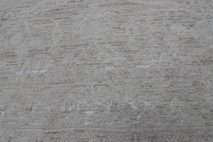 Authentic hand-knotted Afghan runner rug from the Ariana Vintage Collection, featuring a brand-new, beautifully distressed geometric design in pale, muted organic wool tones.