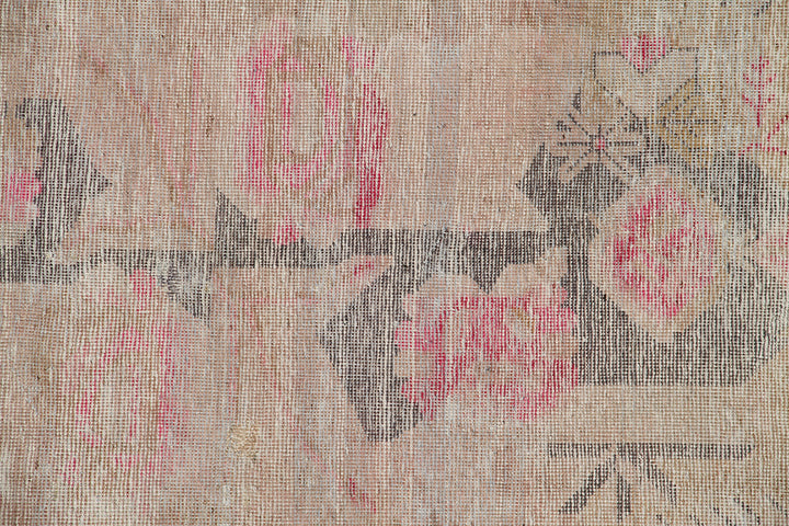 Antique Samarkand wool rug measuring 6'3" x 4'1" featuring a beige and pink color palette with a delicate faded floral design.