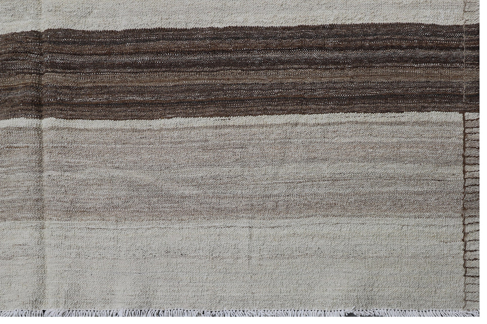 Contemporary living room styled with a 6x9 taupe, brown, and cream striped Afghan wool kilim from Ariana Rugs West Hollywood.