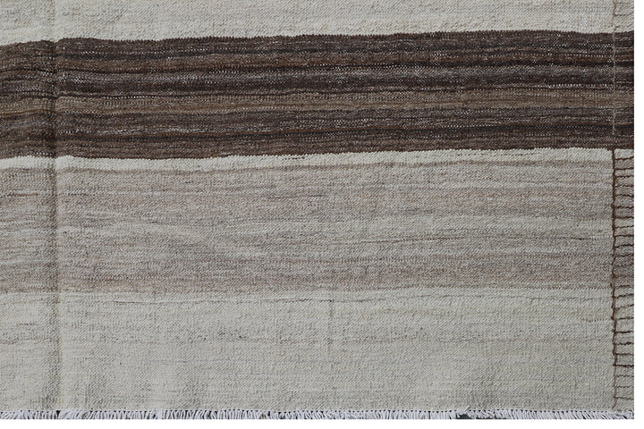 Contemporary living room styled with a 6x9 taupe, brown, and cream striped Afghan wool kilim from Ariana Rugs West Hollywood.