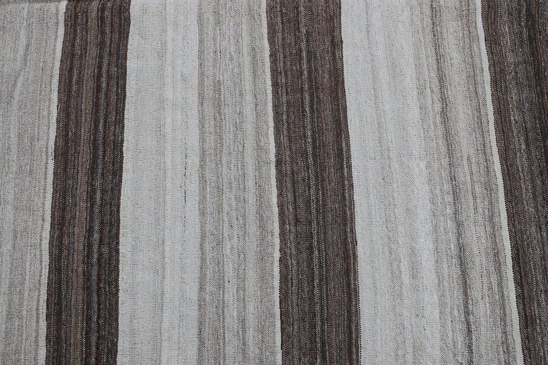 Contemporary living room styled with a 6x9 taupe, brown, and cream striped Afghan wool kilim from Ariana Rugs West Hollywood.