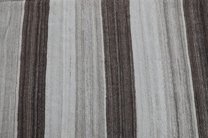 Contemporary living room styled with a 6x9 taupe, brown, and cream striped Afghan wool kilim from Ariana Rugs West Hollywood.