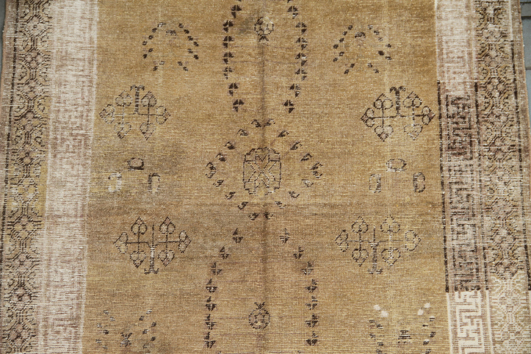 Vintage antique Samarkand Khotan hand-knotted wool runner measuring 8'9" x 4'7" featuring a luminous gold, white, and brown color palette.
