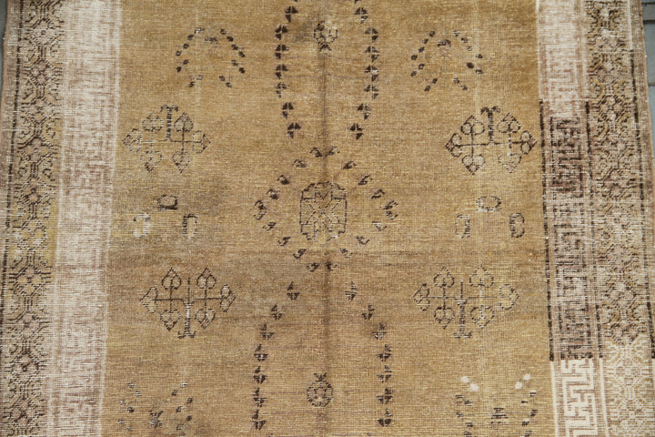 Vintage antique Samarkand Khotan hand-knotted wool runner measuring 8'9" x 4'7" featuring a luminous gold, white, and brown color palette.