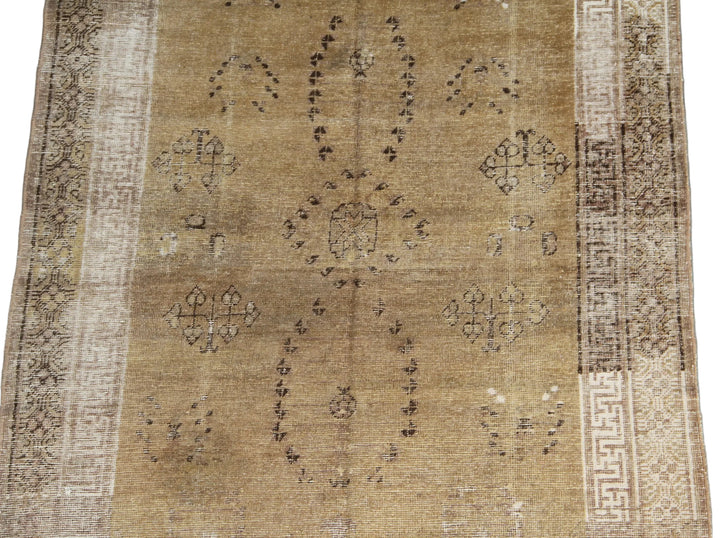 Vintage antique Samarkand Khotan hand-knotted wool runner measuring 8'9" x 4'7" featuring a luminous gold, white, and brown color palette.