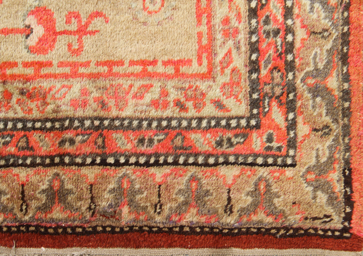 Antique Samarkand Khotan hand-knotted wool rug measuring 9'0" x 5'0" featuring a geometric medallion design in gold, yellow, pink, red, and brown.