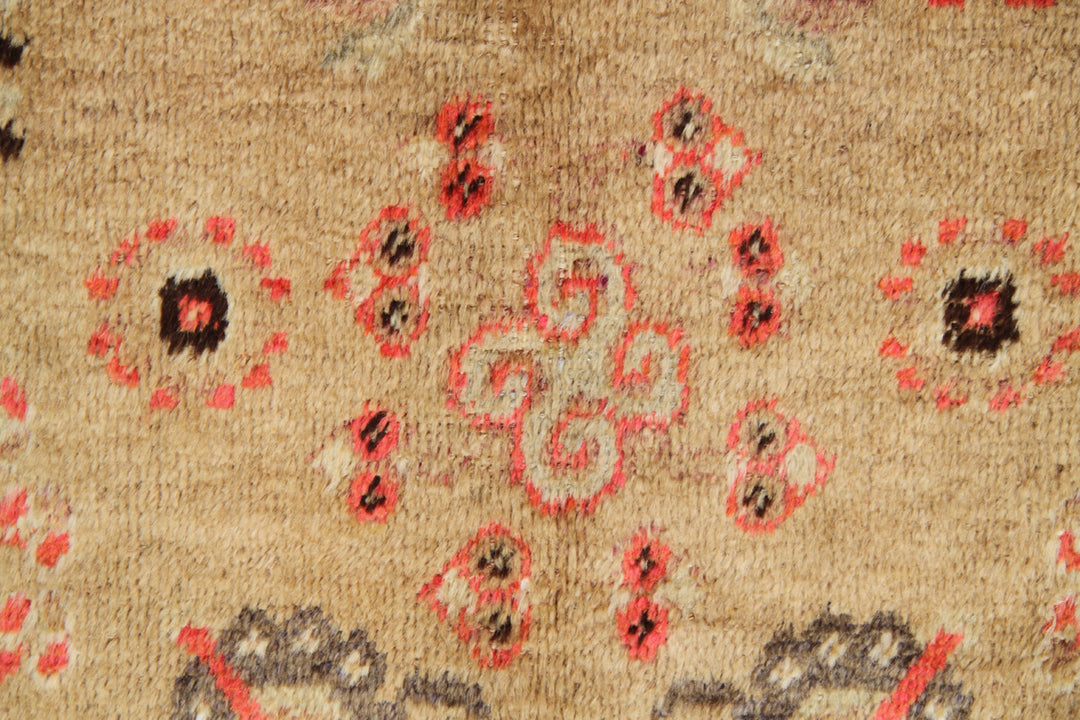 Antique Samarkand Khotan hand-knotted wool rug measuring 9'0" x 5'0" featuring a geometric medallion design in gold, yellow, pink, red, and brown.