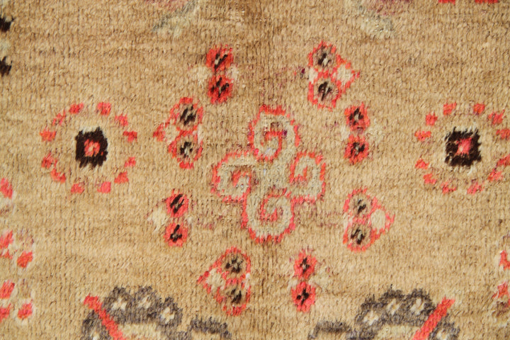 Antique Samarkand Khotan hand-knotted wool rug measuring 9'0" x 5'0" featuring a geometric medallion design in gold, yellow, pink, red, and brown.