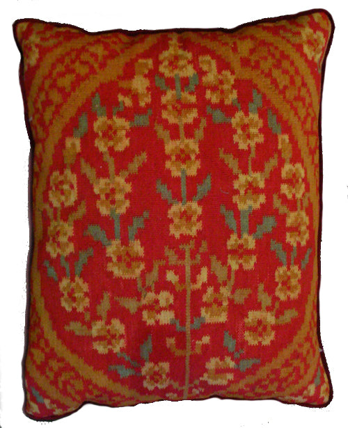 Close-up of a red and green handwoven wool kilim pillowcase with yellow Ottoman geometric patterns.