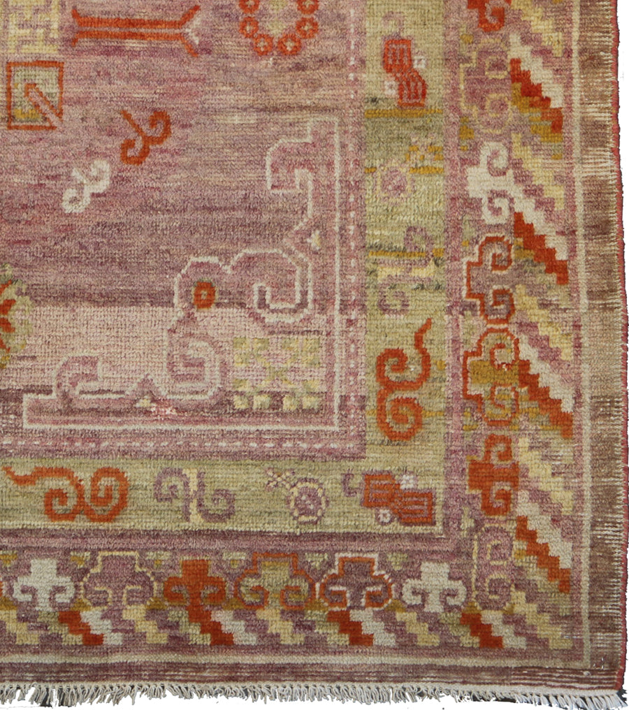 Vintage antique Samarkand Khotan hand-knotted wool runner measuring 7'11" x 3'9" featuring a geometric medallion design in purple, pink, reds, and mauve.
