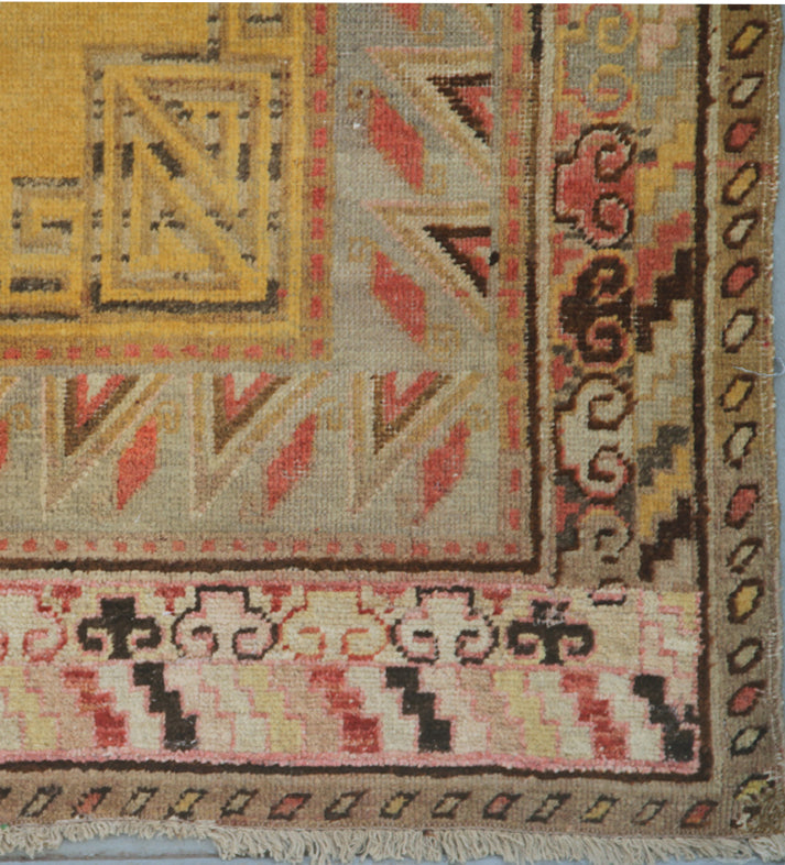 Rare antique hand-knotted Samarkand Khotan wool area rug featuring a central medallion on a unique luminous yellow field