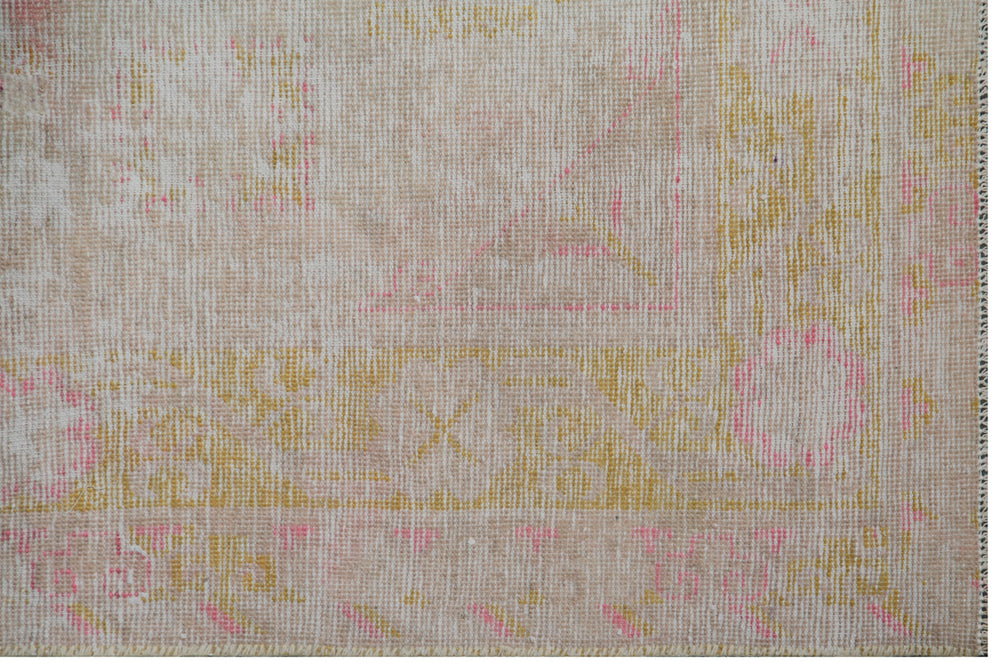 Soft pink and gold vintage antique Samarkand Khotan runner measuring 8'1" x 4'2" featuring a low-pile wool construction and floral design.